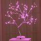 🎄 PearlGlow™ LED Christmas Tree Light in pink mode with delicate LED tips on silver branches, creating a soft, romantic glow for nightstands or mantels.