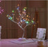 🎄 PearlGlow™ LED Christmas Tree Light with multicolor LED pearls on silver branches, perfect for cozy holiday décor in living rooms or bedrooms.