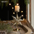 Retro Iron Christmas Candlestick Decorations with star design, featuring a candle on a festive table setting.