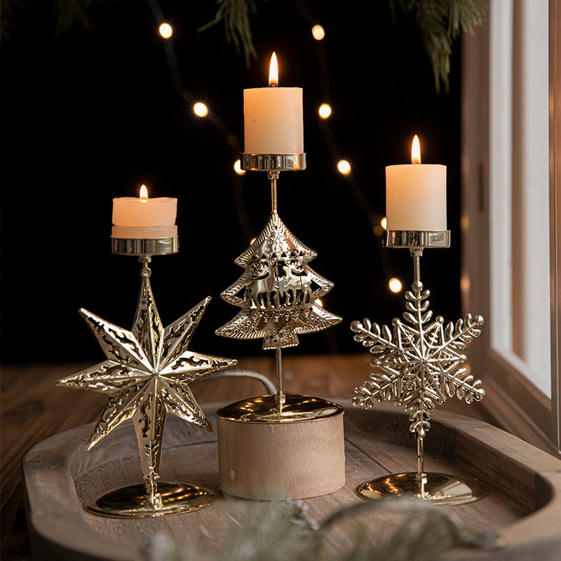 Retro Iron Christmas candlestick decorations with star, tree, and snowflake designs, featuring lit candles.
