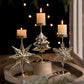 Retro Iron Christmas candlestick decorations with star, tree, and snowflake designs, featuring lit candles.