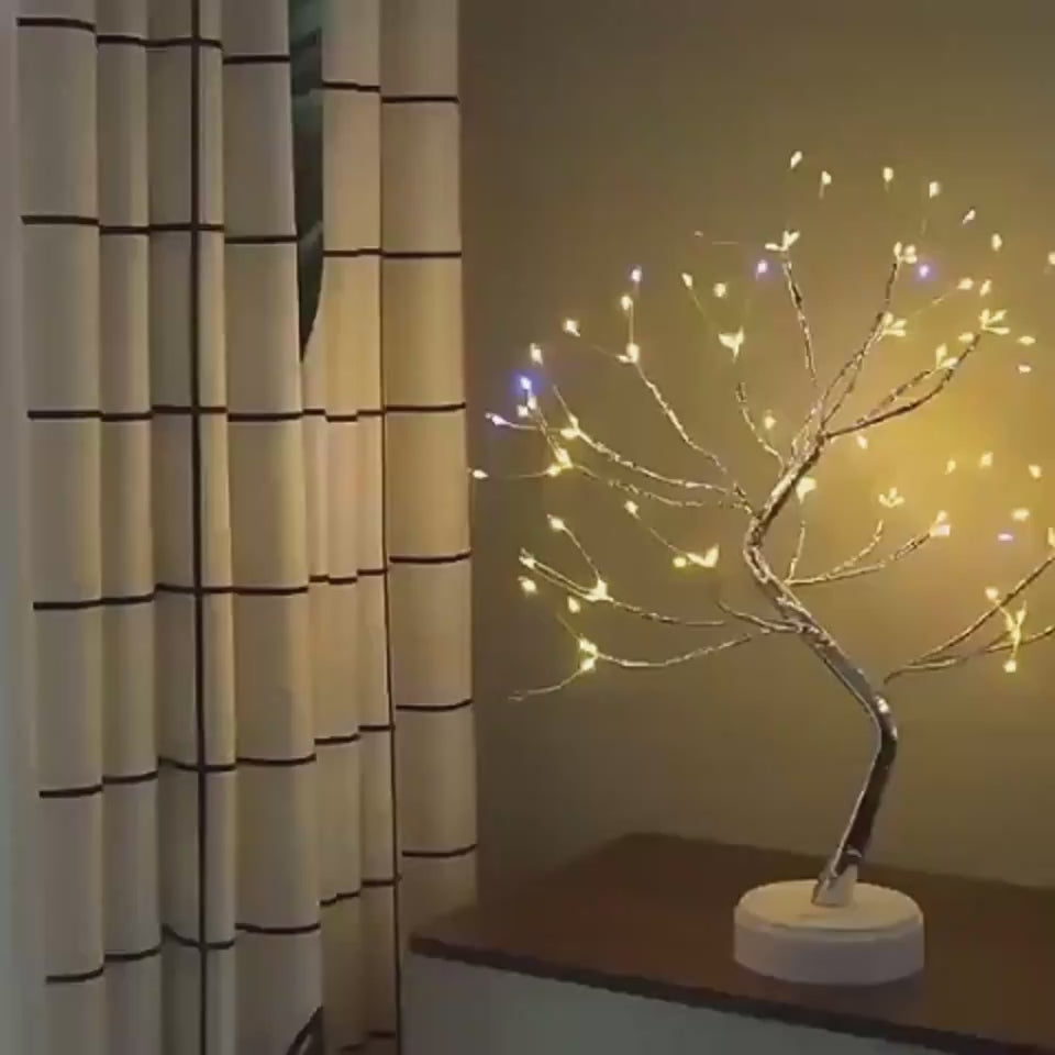 🎄 PearlGlow™ LED Christmas Tree Light with warm yellow and blue LEDs on silver branches, adding festive charm to any tabletop or corner space.